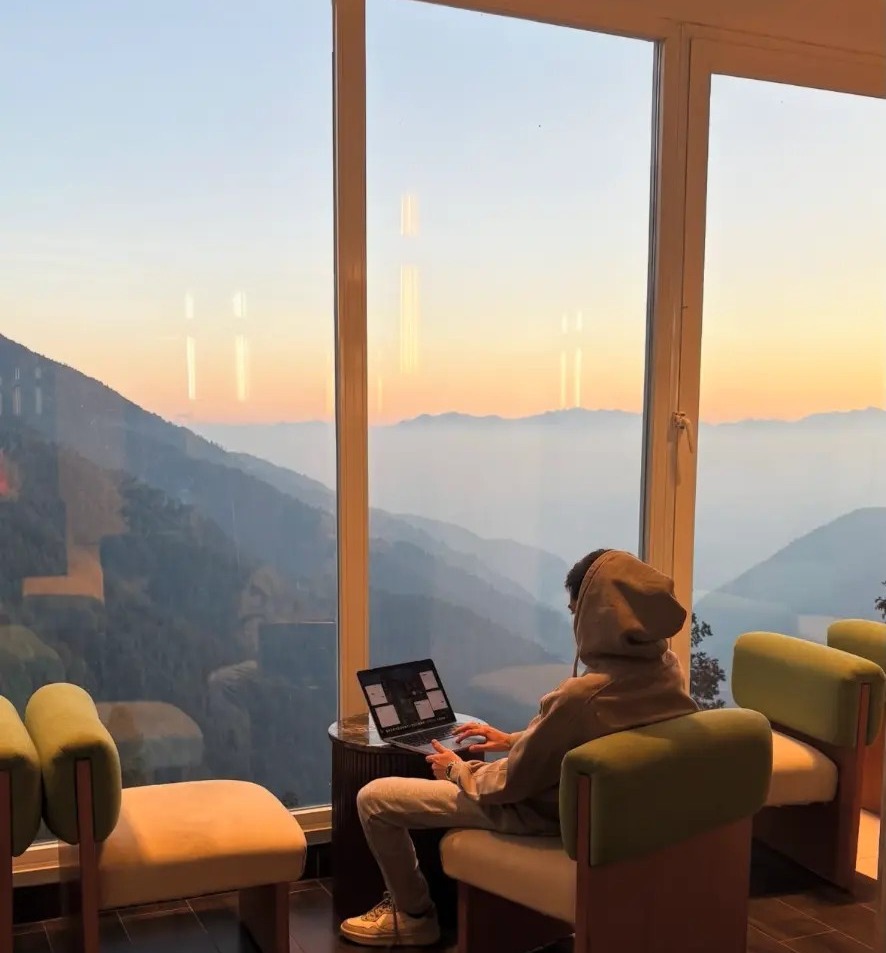 Furqan Sheikh operating remotely from a mountain-view workspace at sunrise